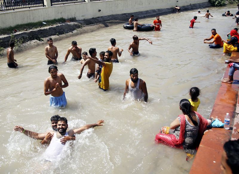 Youth beat the heat in Ranbir canal of Jammu on Friday. -Excelsior/Rakesh