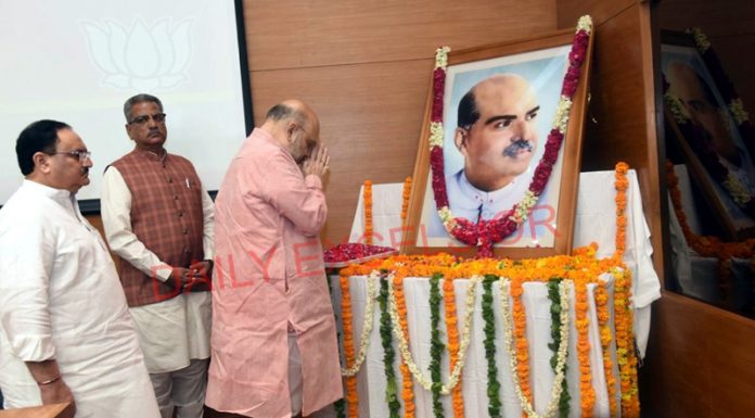 BJP president and Union Home Minister Amit Shah and BJP working president J P Nadda paying floral tributes to Dr S P Mookerjee on his Martyr Day at BJP Headquarters in New Delhi on Sunday. (UNI)