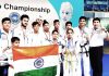 Medal winners of J&K in 3rd South Asian ITF Taekwondo C’ship holding National Flag while posing for a group photograph.