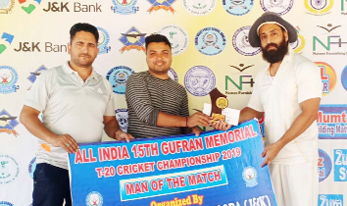 Winner receiving man of the match award from officials during Gufran T20 at Doda.
