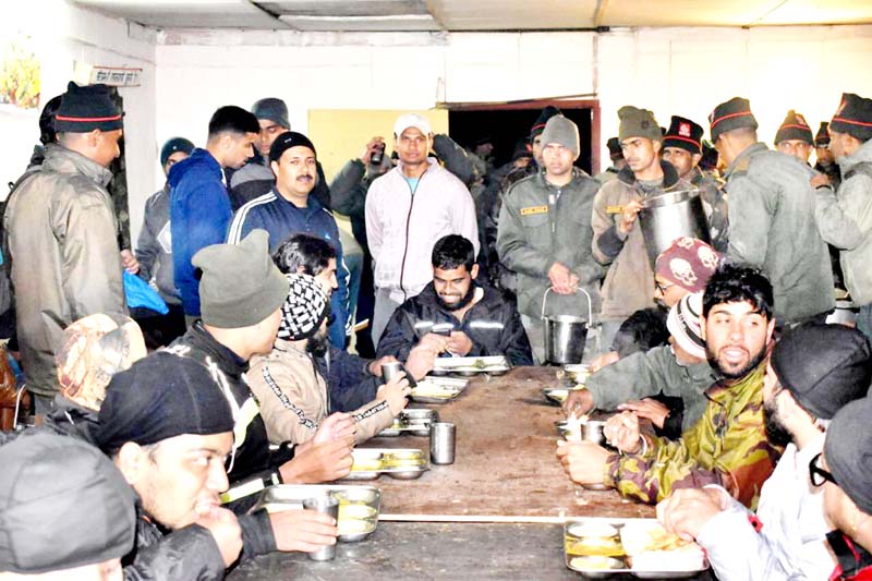 Army personnel providing food to stranding tourists in Ladakh on Friday. Army personnel providing food to stranding tourists in Ladakh on Friday.