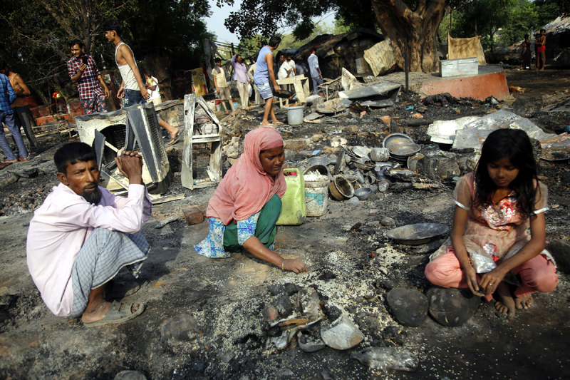 A woman busy in collecting left over items. — Excelsior/Rakesh A woman busy in collecting left over items. — Excelsior/Rakesh