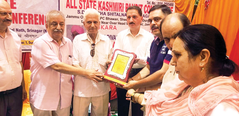 Relief Commissioner T K Bhat and ASKPC leaders presenting a samman at a function at Durga Nagar, ASKPC Bhawan on Sunday.