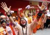 Sadhus singing bhajans and dancing in front of a registration counter at Jammu on Monday. -Excelsior/Rakesh