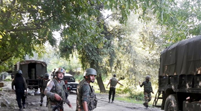 Troops at the site of encounter at Bijbehara, Anantnag on Tuesday. -Excelsior/Sajjad Dar