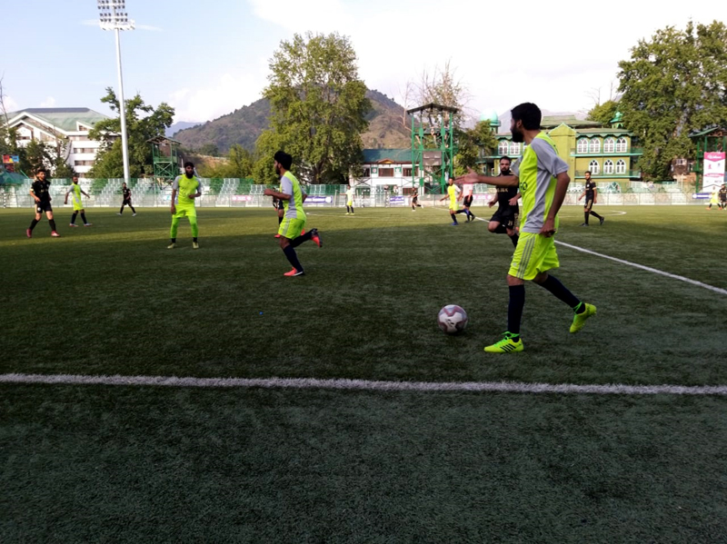 Footballers in action during a match of State Football League Tournament in Srinagar. Footballers in action during a match of State Football League Tournament in Srinagar.