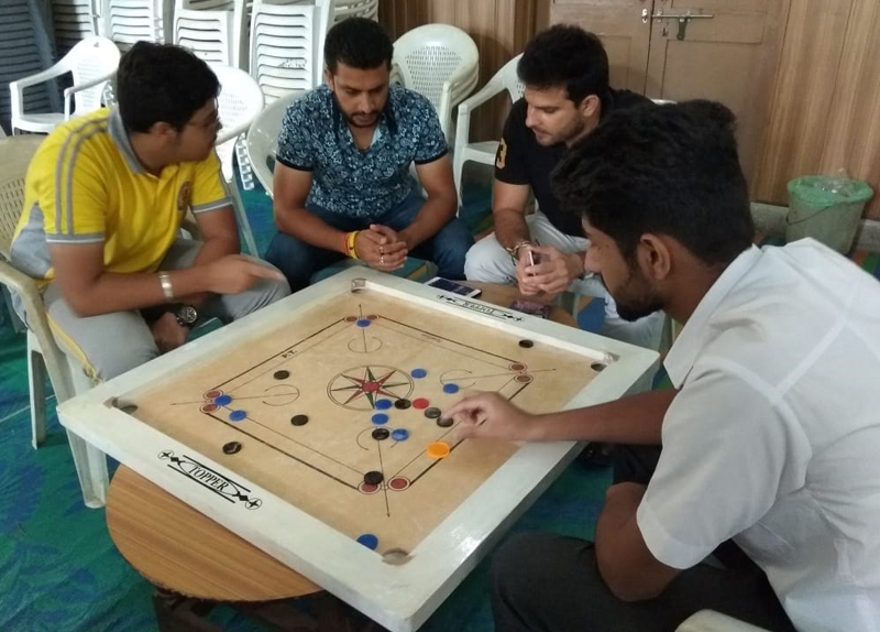 Players showing keen interest during a carrom match of District Level Inter School Tournament in Jammu.