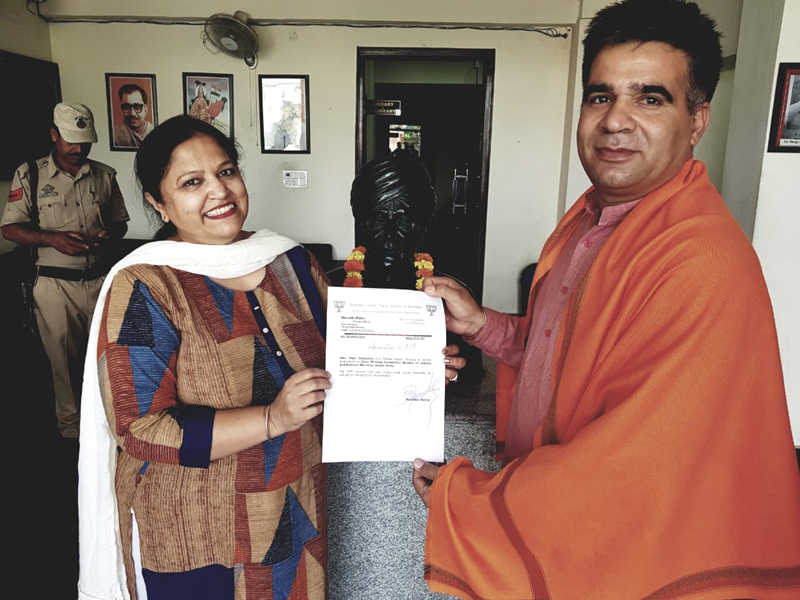 Rajni Rohmetra who was nominated as State Working Committee Member of BJP receiving letter from State president, Ravinder Raina at BJP Headquarters, Trikuta Nagar, Jammu on Monday.