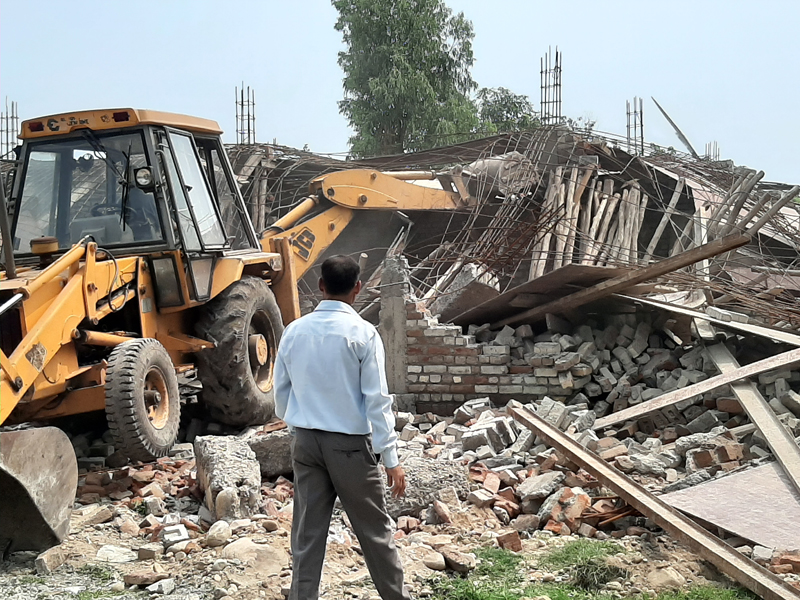 A JCB demolishing an illegal structure in Kathua town on Monday. — Excelsior/Pardeep A JCB demolishing an illegal structure in Kathua town on Monday. — Excelsior/Pardeep