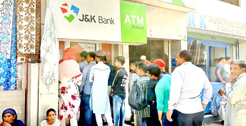 Locals in Mendhar town waiting outside an ATM for withdrawing money. Locals in Mendhar town waiting outside an ATM for withdrawing money.