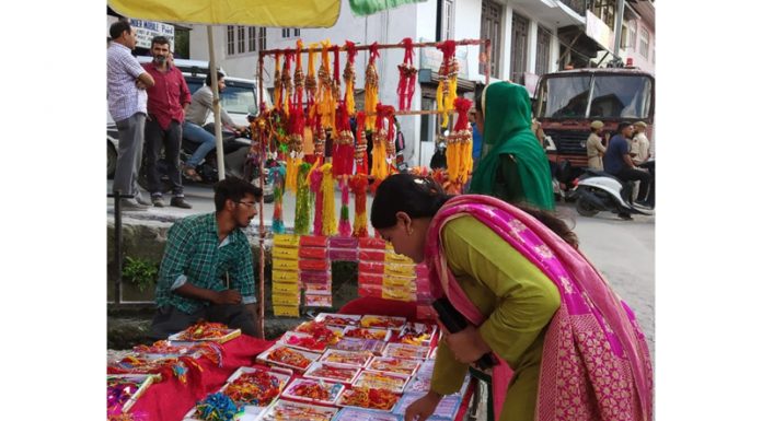 A woman selects ‘Rakhis’ as markets re-open in Bhaderwah on Sunday. —Excelsior/Tilak Raj