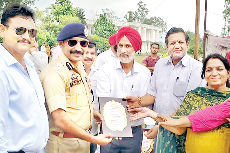 Principal GDC Udhampur Dr Nutan Kumar Resotra and others presenting trophy to SSP Mohan Lal. Principal GDC Udhampur Dr Nutan Kumar Resotra and others presenting trophy to SSP Mohan Lal.