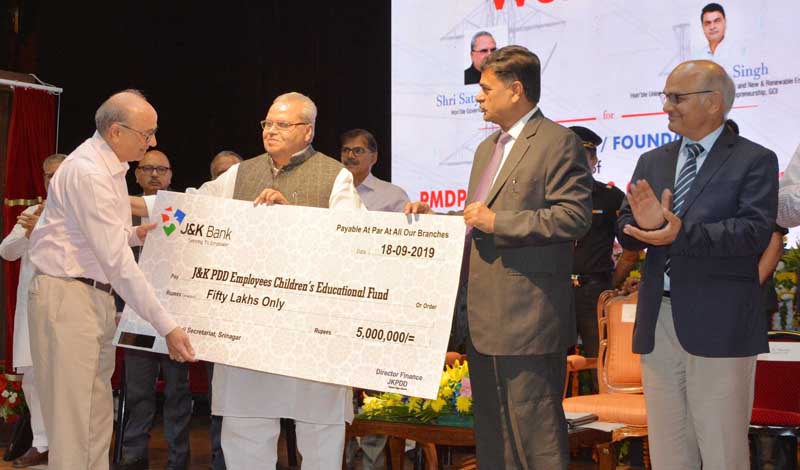 Governor Satya Pal Malik and Union MoS Power R K Singh giving away cheque to JKPDD on Wednesday. Governor Satya Pal Malik and Union MoS Power R K Singh giving away cheque to JKPDD on Wednesday.