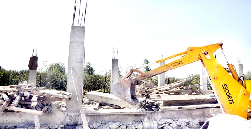 A structure being demolished. A structure being demolished.