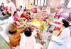 Devotees participating in Purnaahuti of Samved Yagya at Arya Samaj Temple, Bakshi Nagar in Jammu.