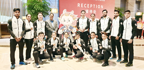 Poonam and other Wushu players posing alongwith chief coach of India Kuldeep Handoo on Sunday. Poonam and other Wushu players posing alongwith chief coach of India Kuldeep Handoo on Sunday.