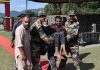 An elderly villager being shifted to Army medical camp by jawans and relatives at Balnoi in Mendhar.