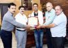 Arun Kumar Jaral, Soil Conservation Assistant, Bhalwal, Jammu posing for photograph with Director Agriculture, Jammu PS Rathore and others after receiving 'Grameen Vikas Purskar'.