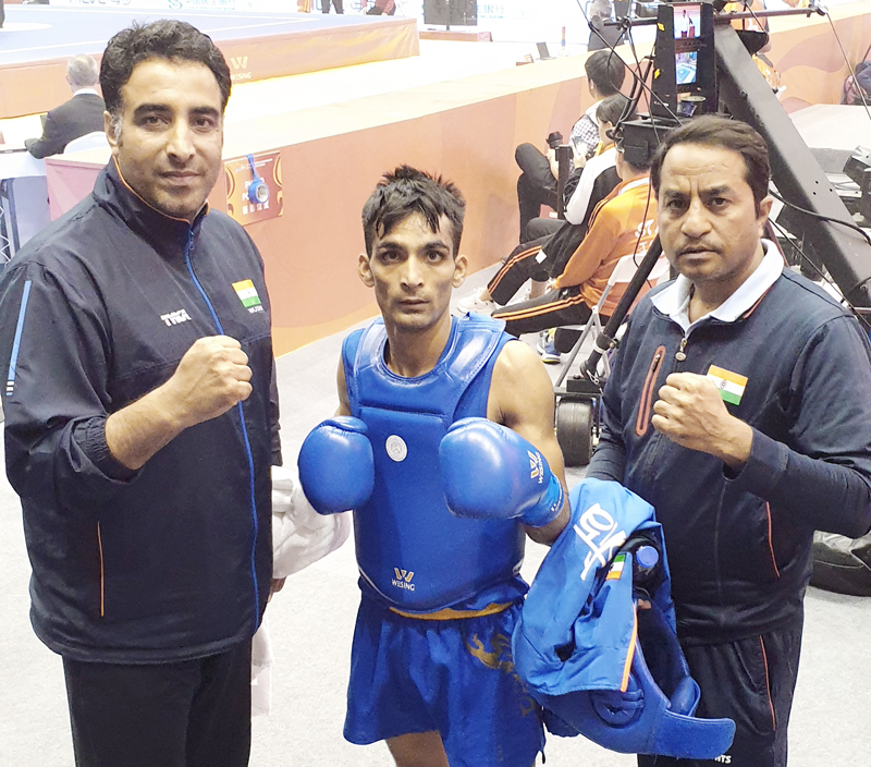 Ace Wushu player Praveen Kumar posing along with coaches in Shanghai. Ace Wushu player Praveen Kumar posing along with coaches in Shanghai.
