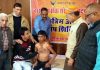 A physically challenged boy being examined by doctor during a free medical camp by Jammu Yatri Bhawan.