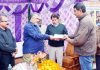 Principal Secy, Dr Asgar Samoon handing over insurance cheque to a farmer at Jammu.