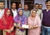 Shilpa Dubey, Sarpanch Dhamore in Vijaypur block handing over a cheque to a poor family on Wednesday. -Excelsior/Gautam