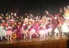 Children presenting colourful cultural item while celebrating Annual Day at Cambridge International School.