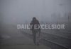 A passenger walks through dense fog at Jammu Railway Station on Monday morning. —Excelsior/Rakesh
