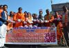 Shiv Sena leaders distributing onions on half rate in Jammu on Sunday.