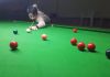 Cueist aiming at target at Billiards Hall, MA Stadium in Jammu.