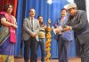 Guests lighting ceremonial lamp during ‘Sham-e-Gazal’ by AIR Jammu.