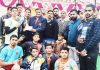 Winners of Kabaddi tournament receiving title trophy from Shiv Kumar Sharma at Sports Stadium Reasi on Sunday.