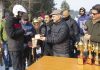 Advisor KK Sharma presenting trophy to winners during a function organized by the Indian Institute of Skiing and Mountaineering at Gulmarg.