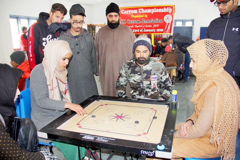 Players in action during Carrom Championship in Srinagar. Players in action during Carrom Championship in Srinagar.