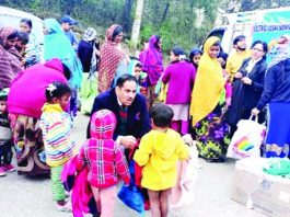 DLSA distributing clothes amongst needy.