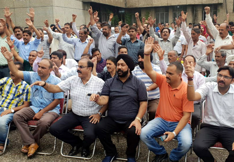 PEECC members raising slogans in support of their demands during a meeting. PEECC members raising slogans in support of their demands during a meeting.