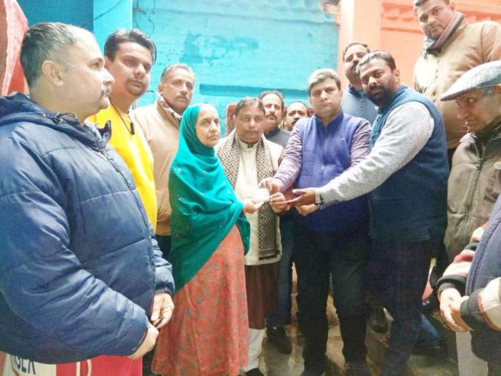 Former Minister, Sat Sharma handing over Ayushman Bharat Card to heart patient at Talab Tillo on Tuesday. Former Minister, Sat Sharma handing over Ayushman Bharat Card to heart patient at Talab Tillo on Tuesday.