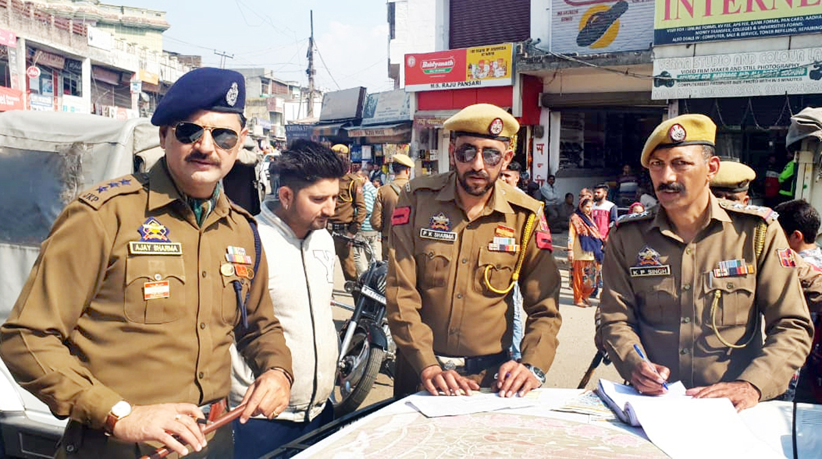 A police team led by SDPO Ajay Sharma challans a youth for traffic violation in Akhnoor town. A police team led by SDPO Ajay Sharma challans a youth for traffic violation in Akhnoor town.