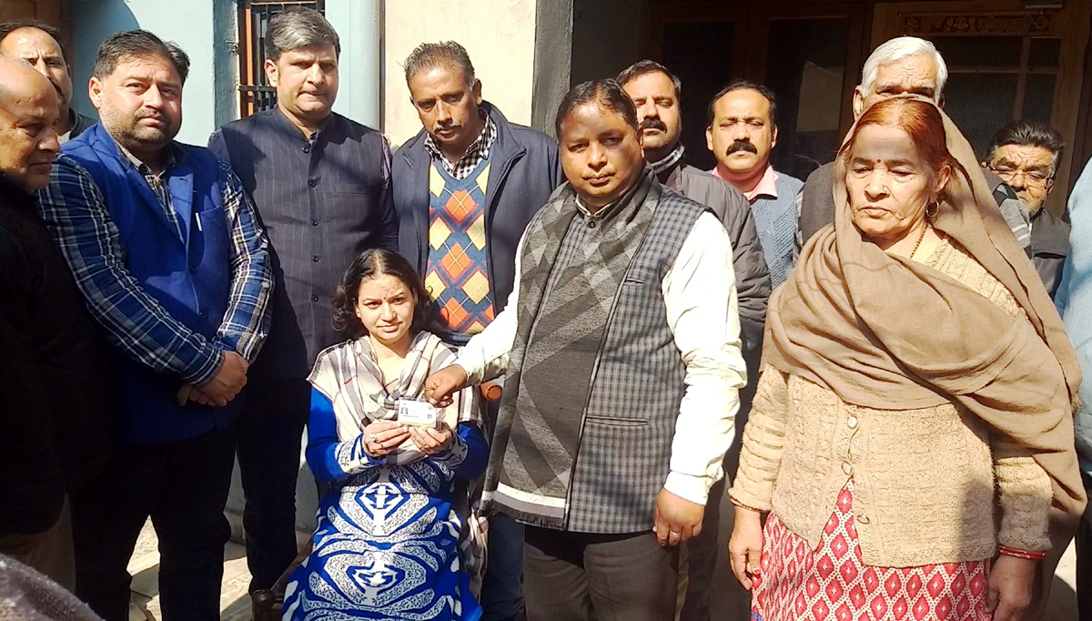 Former MLA, Sat Sharma handing over Ayushman Bharat card to a patient at Jammu on Saturday. Former MLA, Sat Sharma handing over Ayushman Bharat card to a patient at Jammu on Saturday.