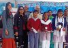 Winner students of the debate competition along with dignitaries posing for a group photograph in Jammu.