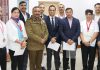 Meritorious JKP shuttlers posing along with DGP Dilbag Singh during felicitation function in Jammu on Monday.