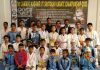 Karatekas posing for a group photograph along with dignitaries and officials in Jammu.