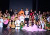 Children in colourful attires posing along with chief guest and other dignitaries during Annual day celebration at Abhinav Theatre in Jammu.