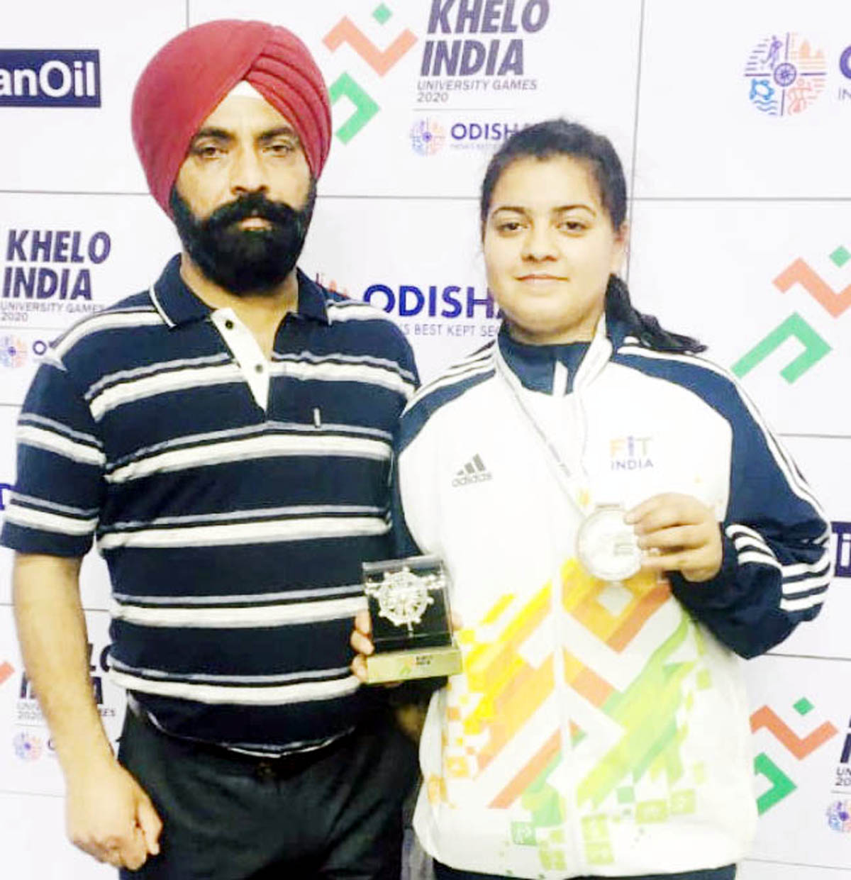 Judoka Shikha Bhau posing along with coach, Suraj Bhan Singh after winning bronze medal in KIUGs. Judoka Shikha Bhau posing along with coach, Suraj Bhan Singh after winning bronze medal in KIUGs.