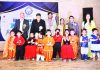 Children in colourful attires posing along with chief guest and other dignitaries during Annual Day celebration at Indo-American Montessori Pre School in Jammu.