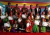 Students of Grooming Kids posing for a group photograph with dignitaries during Annual Day function.