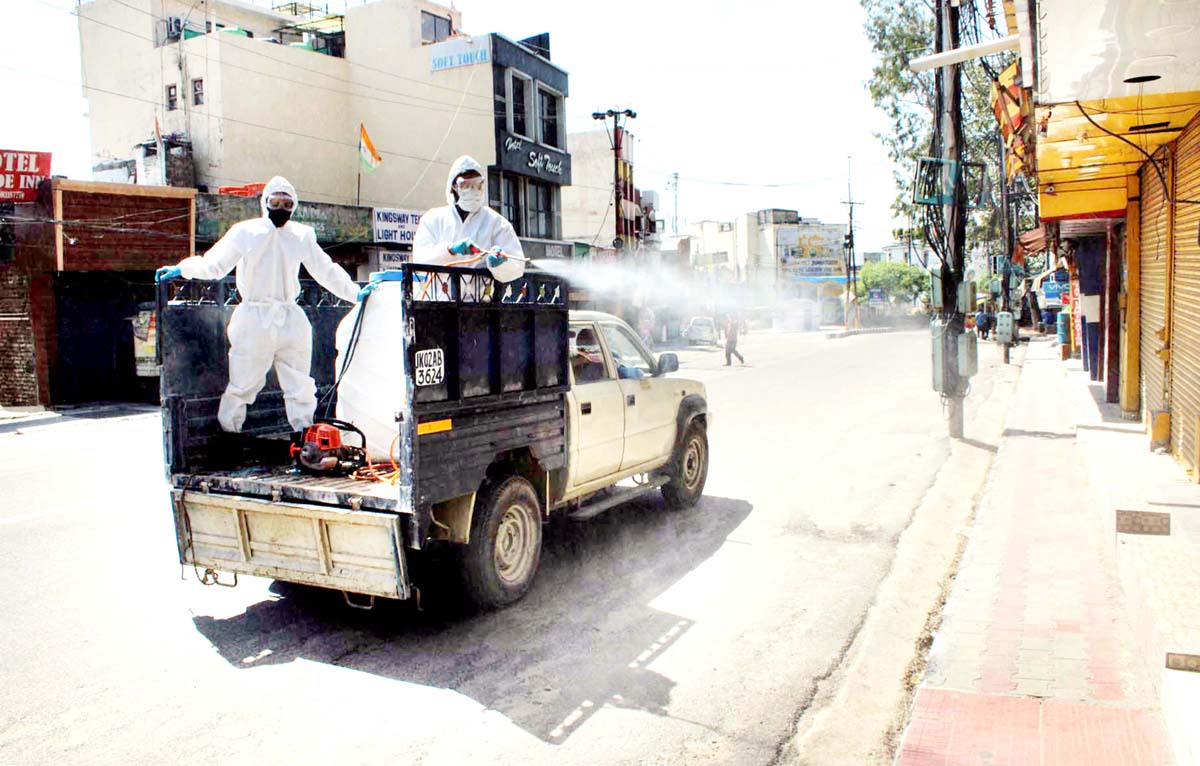 Frontline workers of JMC spraying disinfectant in a Jammu city area on Sunday. Frontline workers of JMC spraying disinfectant in a Jammu city area on Sunday.