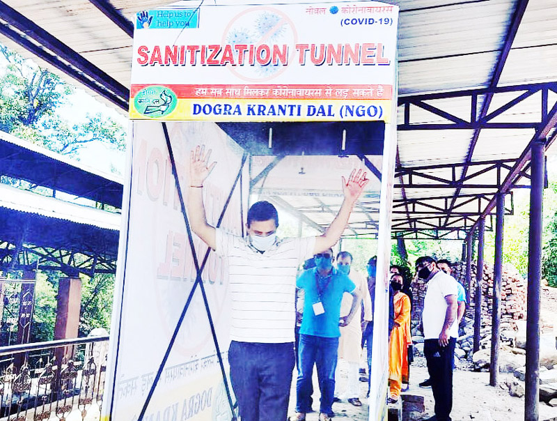 Former MLA Balwant Singh Mankotia passing through a sanitization tunnel at Devika Ghat in Udhampur. Former MLA Balwant Singh Mankotia passing through a sanitization tunnel at Devika Ghat in Udhampur.