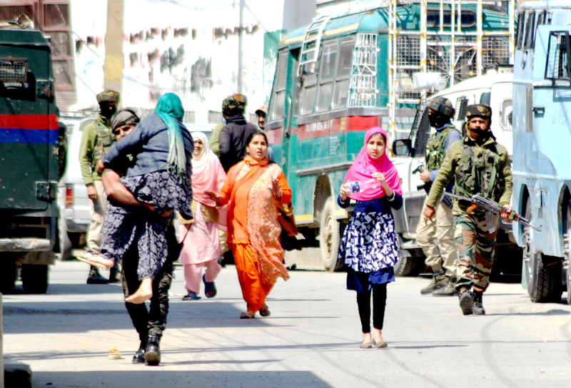 Security personnel evacuate an old woman from the encounter site at Nawakadal in Srinagar on Tuesday. -Excelsior/Shakeel Security personnel evacuate an old woman from the encounter site at Nawakadal in Srinagar on Tuesday. -Excelsior/Shakeel