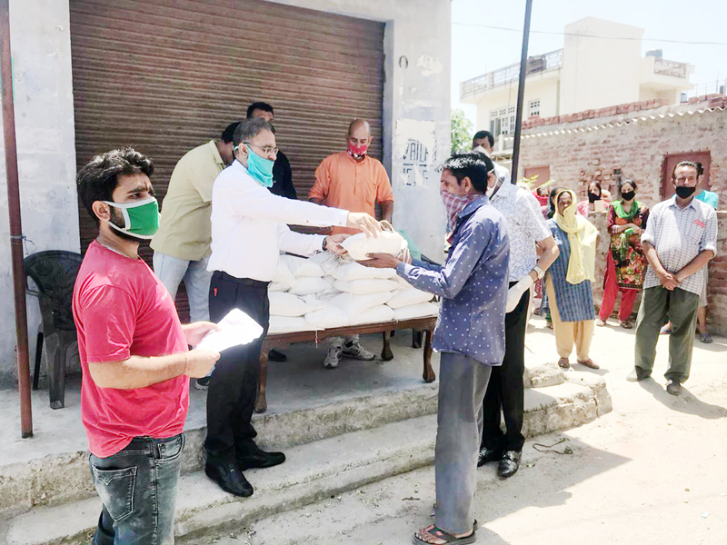 Former Deputy CM, Kavinder Gupta distributing ration at Gadi Garh on Wednesday. Former Deputy CM, Kavinder Gupta distributing ration at Gadi Garh on Wednesday.